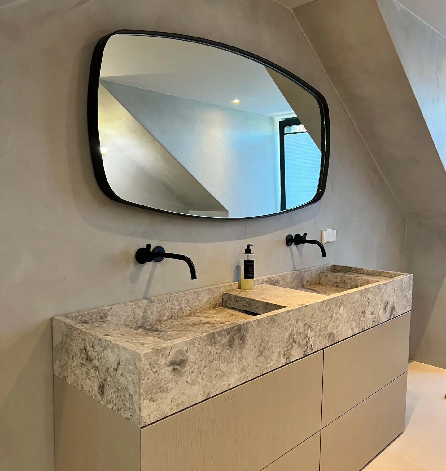 Marble double-basin vanity with round mirror