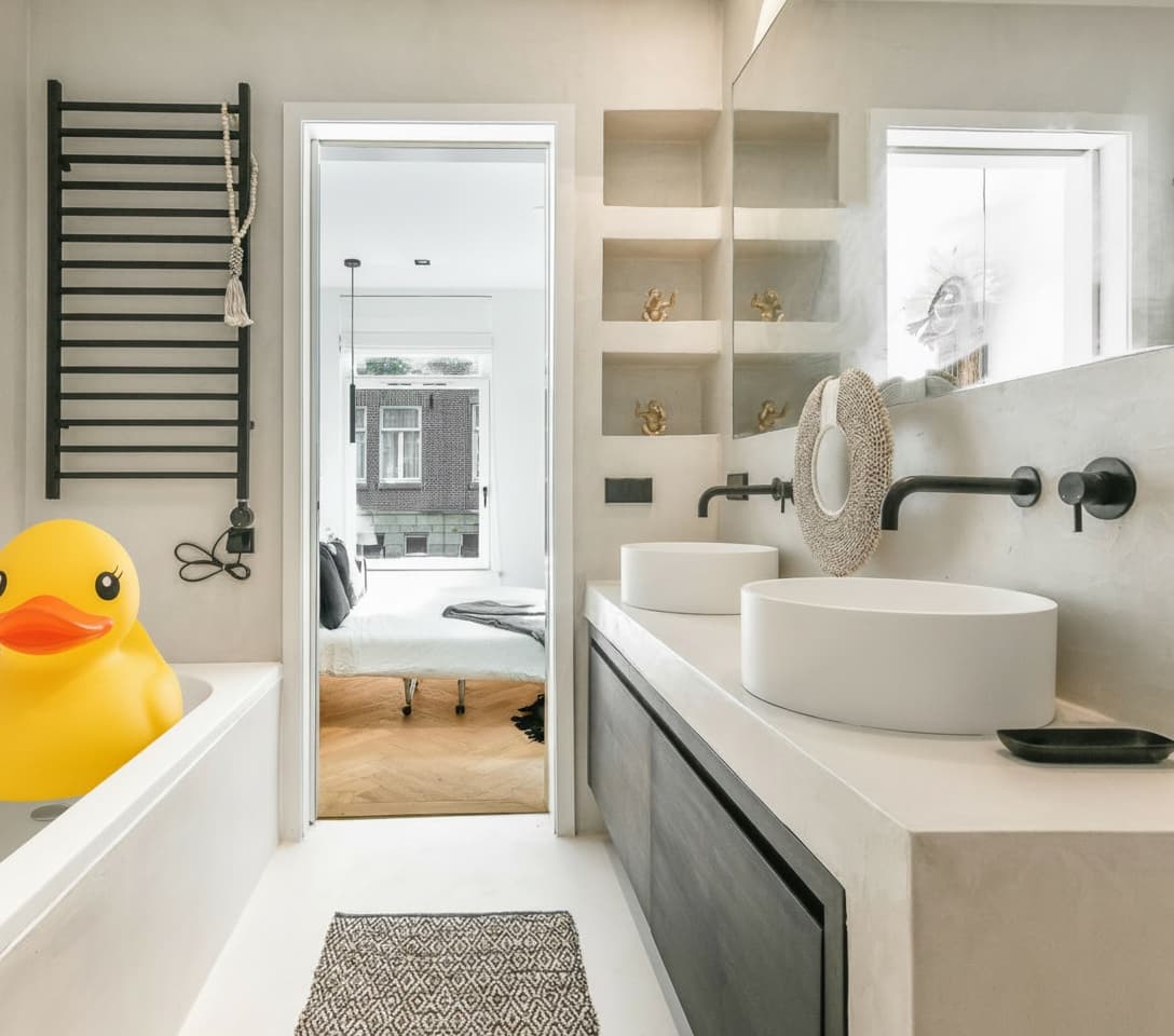 Bright modern bathroom with freestanding bath and twin vanity