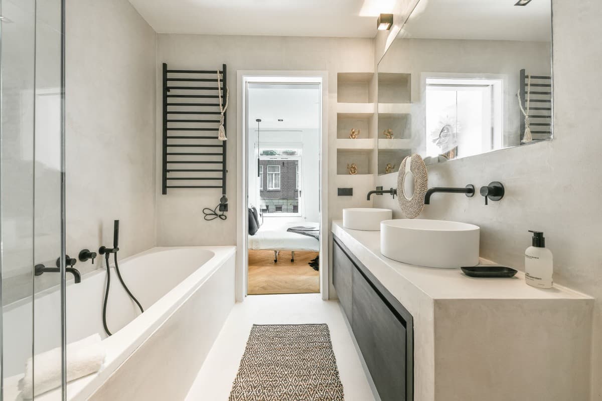 Bathroom with freestanding bath, twin vanity and statement mirror