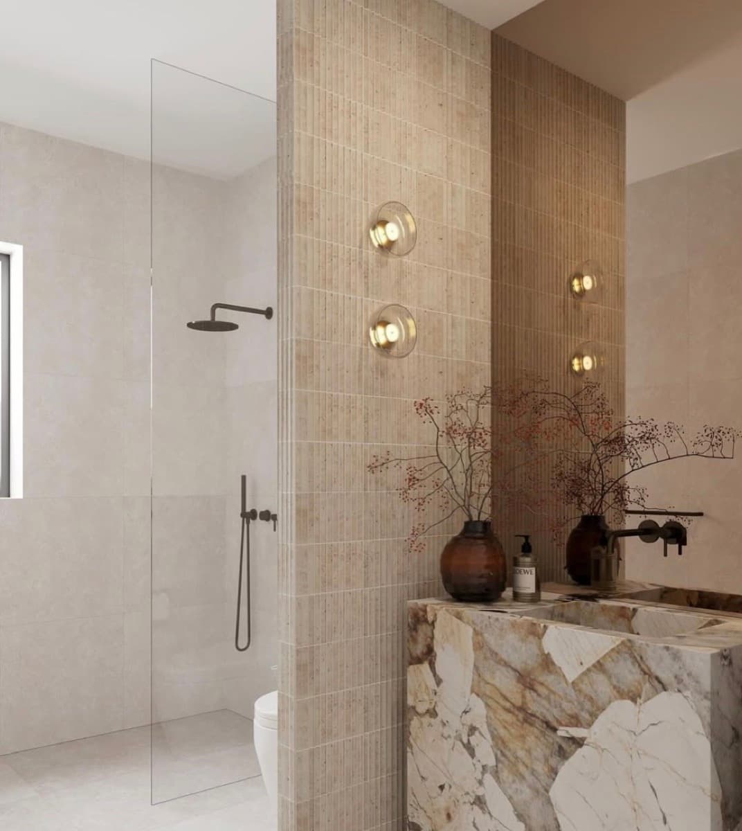 Shower area framed by a fluted marble feature wall