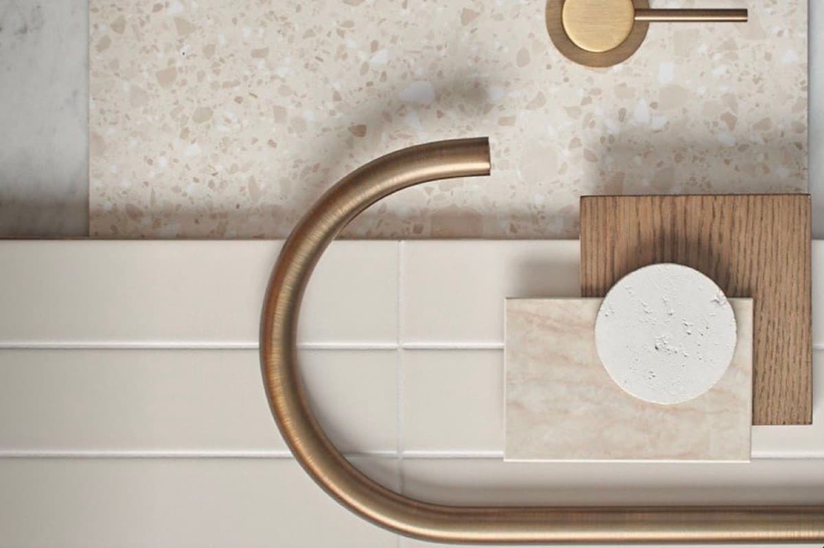 Materials moodboard with terrazzo, marble and brass tapware